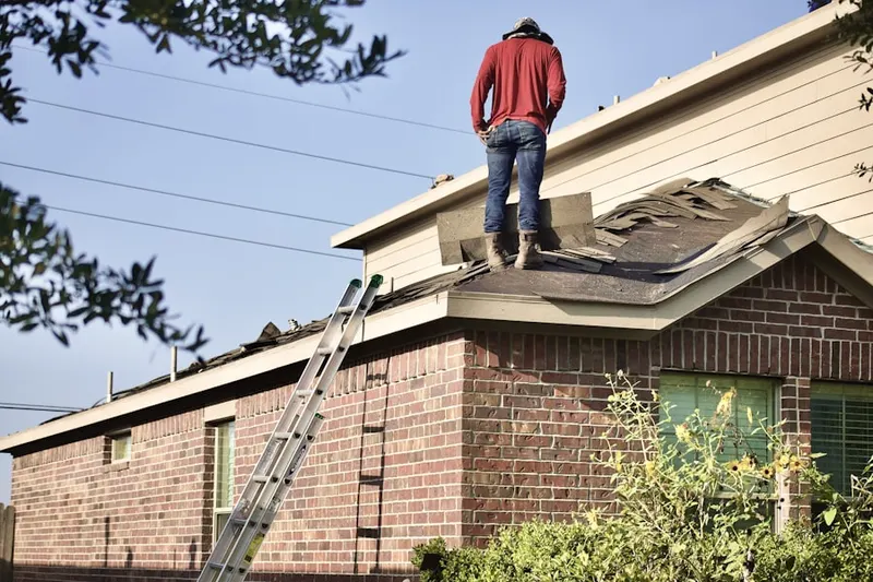 Professional roofer working on a residential roof in South Farms